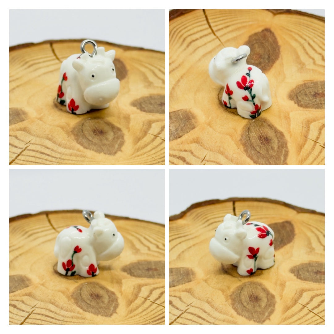 All pendants feature a miniature cow and are hand-painted.