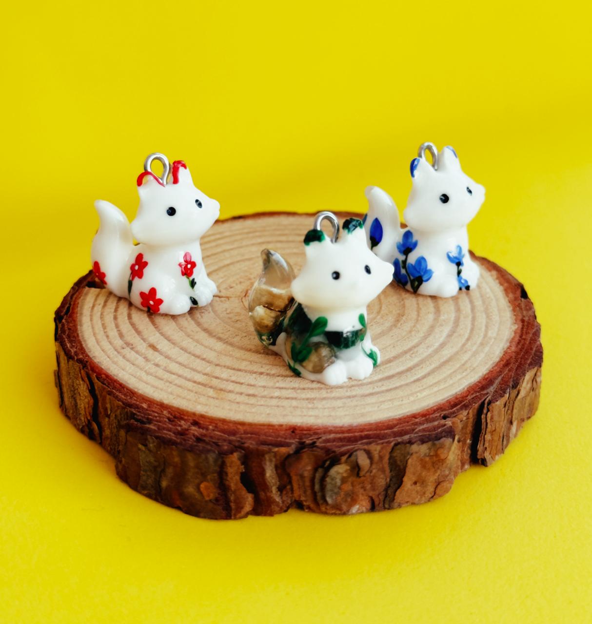 All pendants feature a miniature fox animal and hand-painted details.