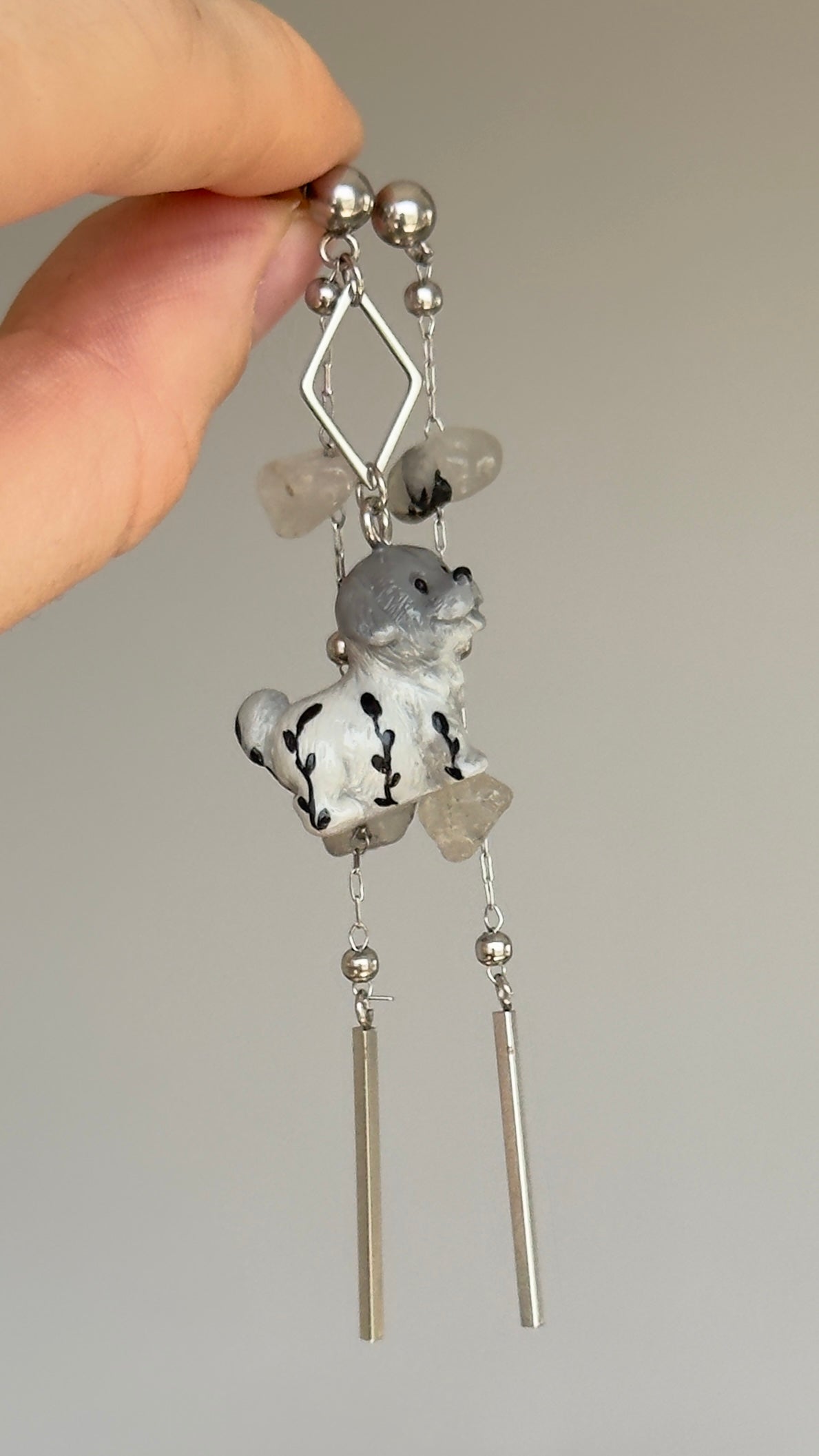 Long asymmetrical gray stainless steel earrings, with a puppy and quartz stones