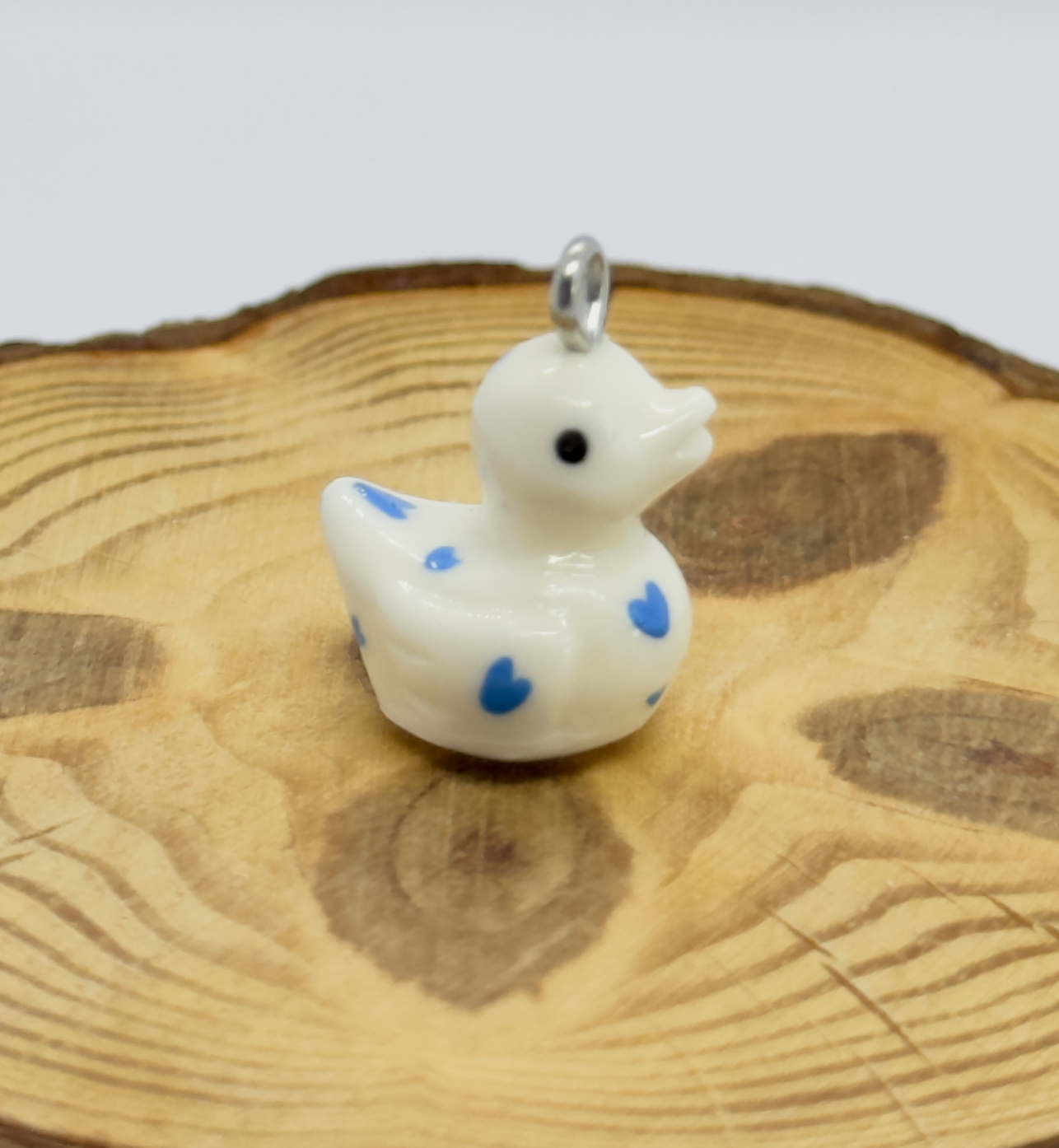All pendants feature a miniature duck animal and hand-painted details.