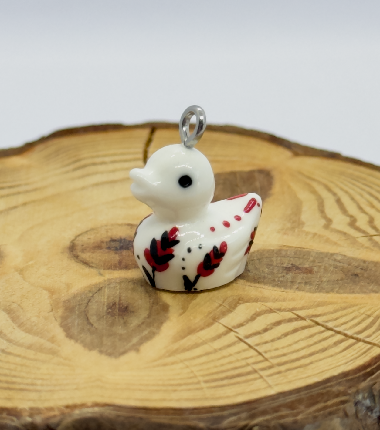 All pendants feature a miniature duck animal and hand-painted details.