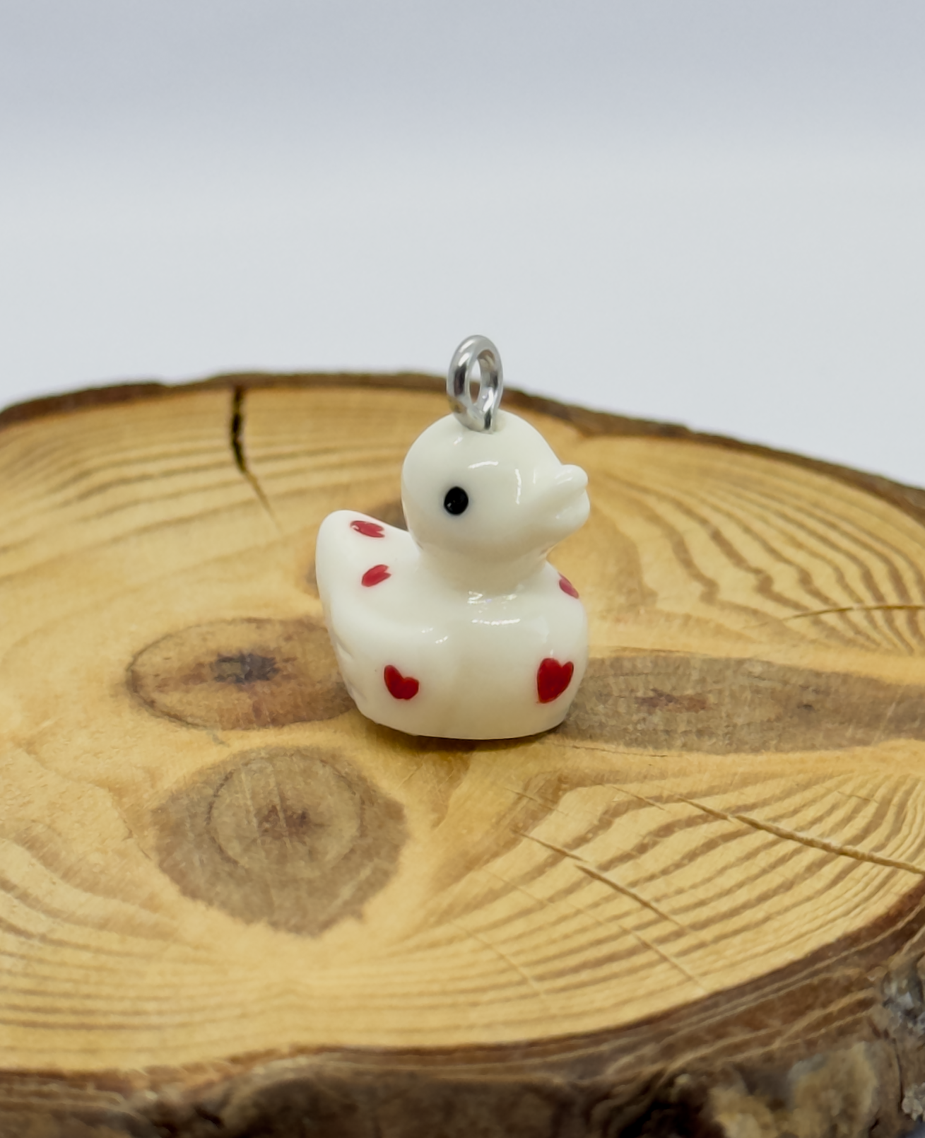 All pendants feature a miniature duck animal and hand-painted details.