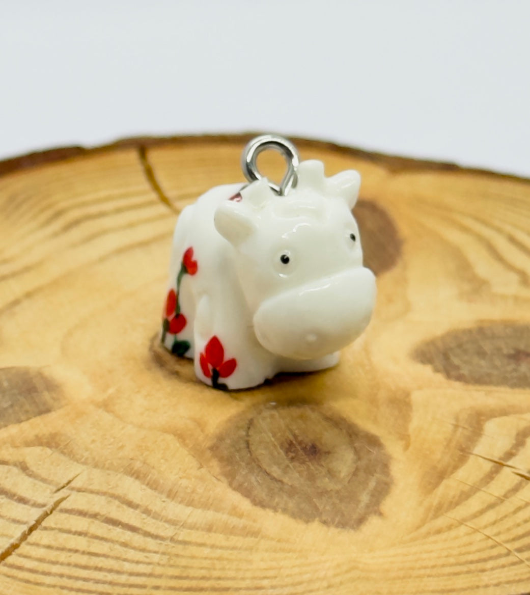 All pendants feature a miniature cow and are hand-painted.