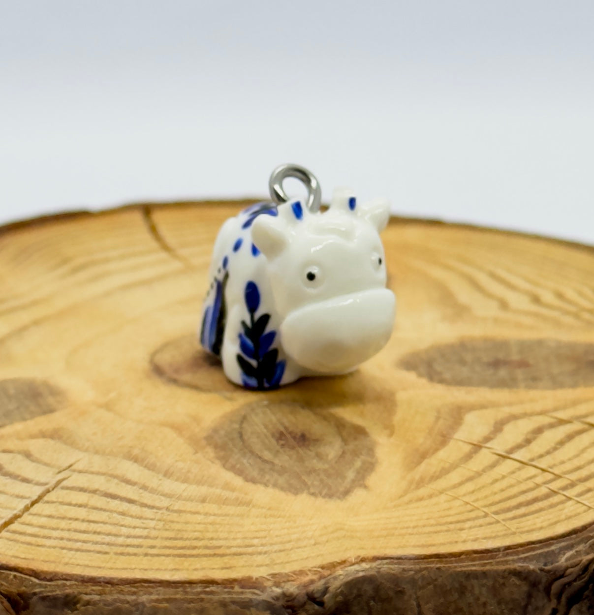 All pendants feature a miniature cow and are hand-painted.