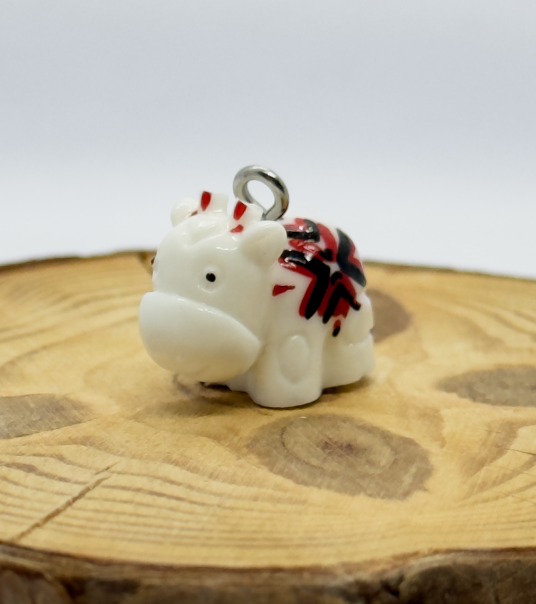 All pendants feature a miniature cow and are hand-painted.