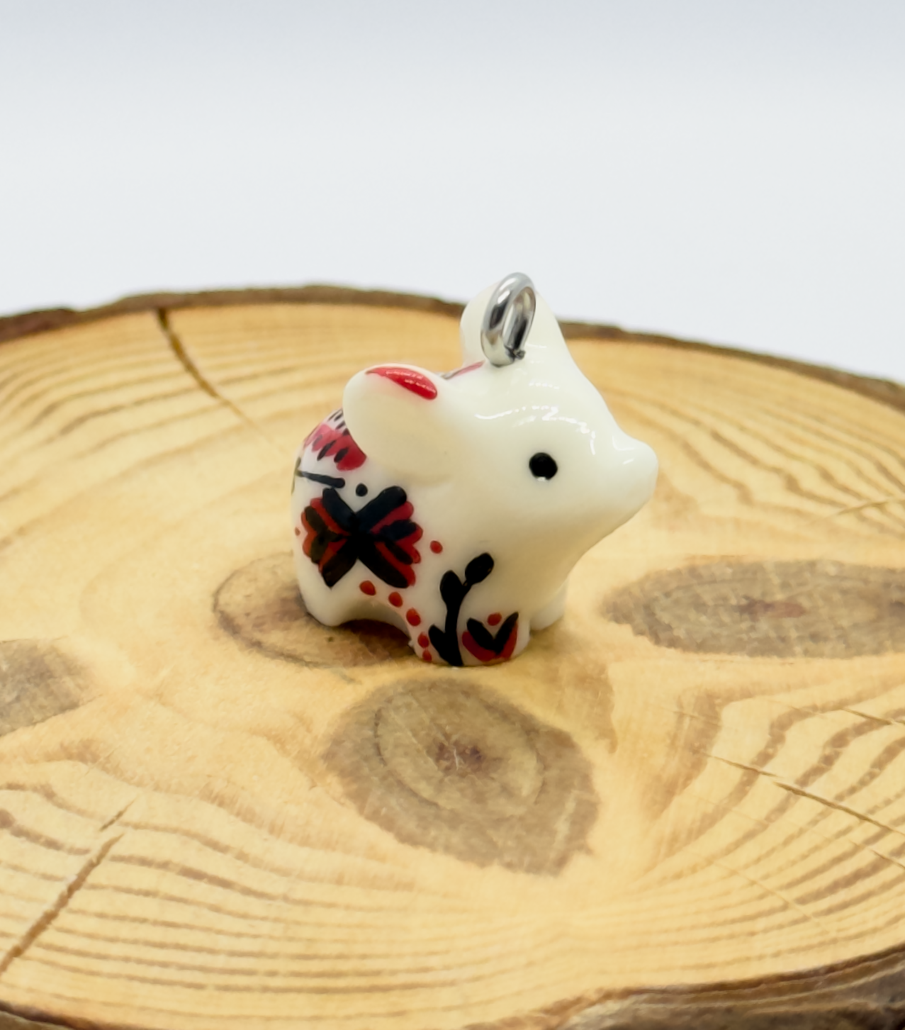 All the pendants feature a miniature piglet animal and are hand-painted.