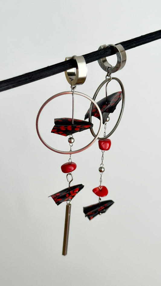 Asymmetrical long earrings with origami airplanes