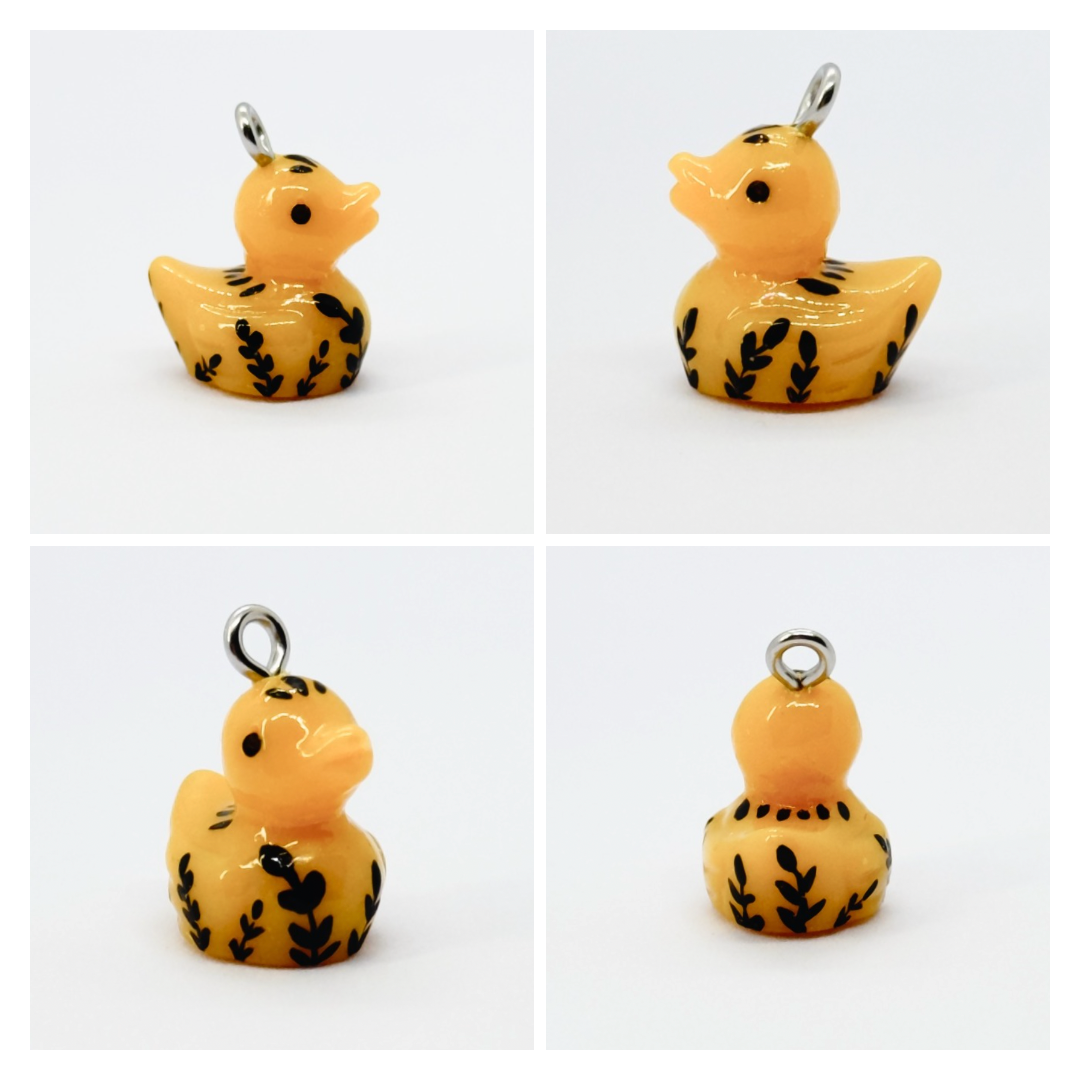 All pendants feature a miniature duck animal and hand-painted details.