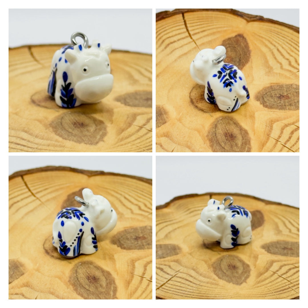 All pendants feature a miniature cow and are hand-painted.