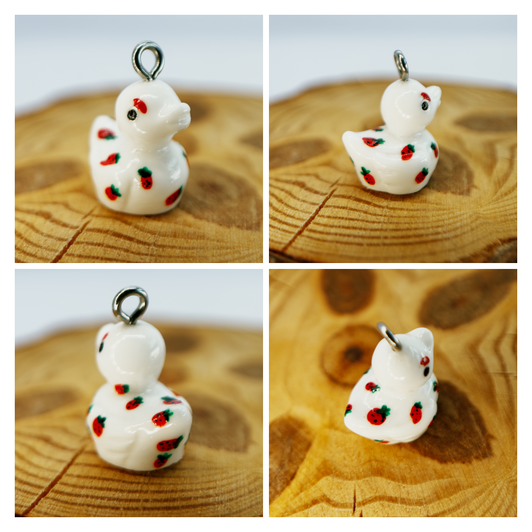 All pendants feature a miniature duck animal and hand-painted details.