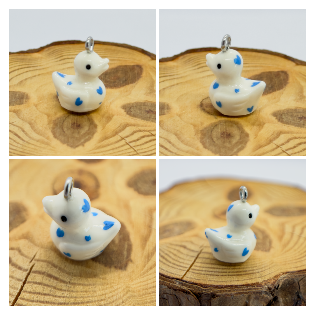 All pendants feature a miniature duck animal and hand-painted details.