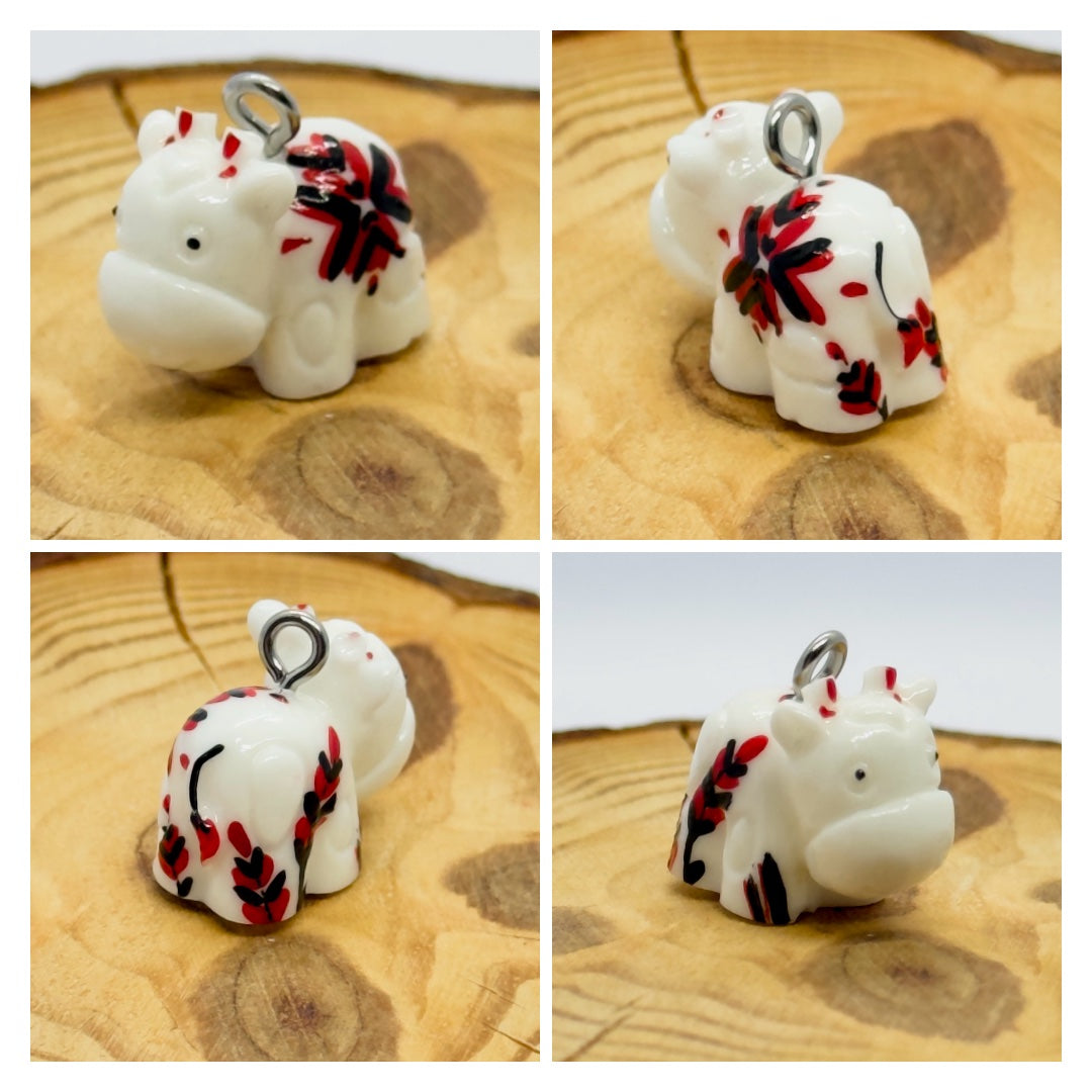 All pendants feature a miniature cow and are hand-painted.
