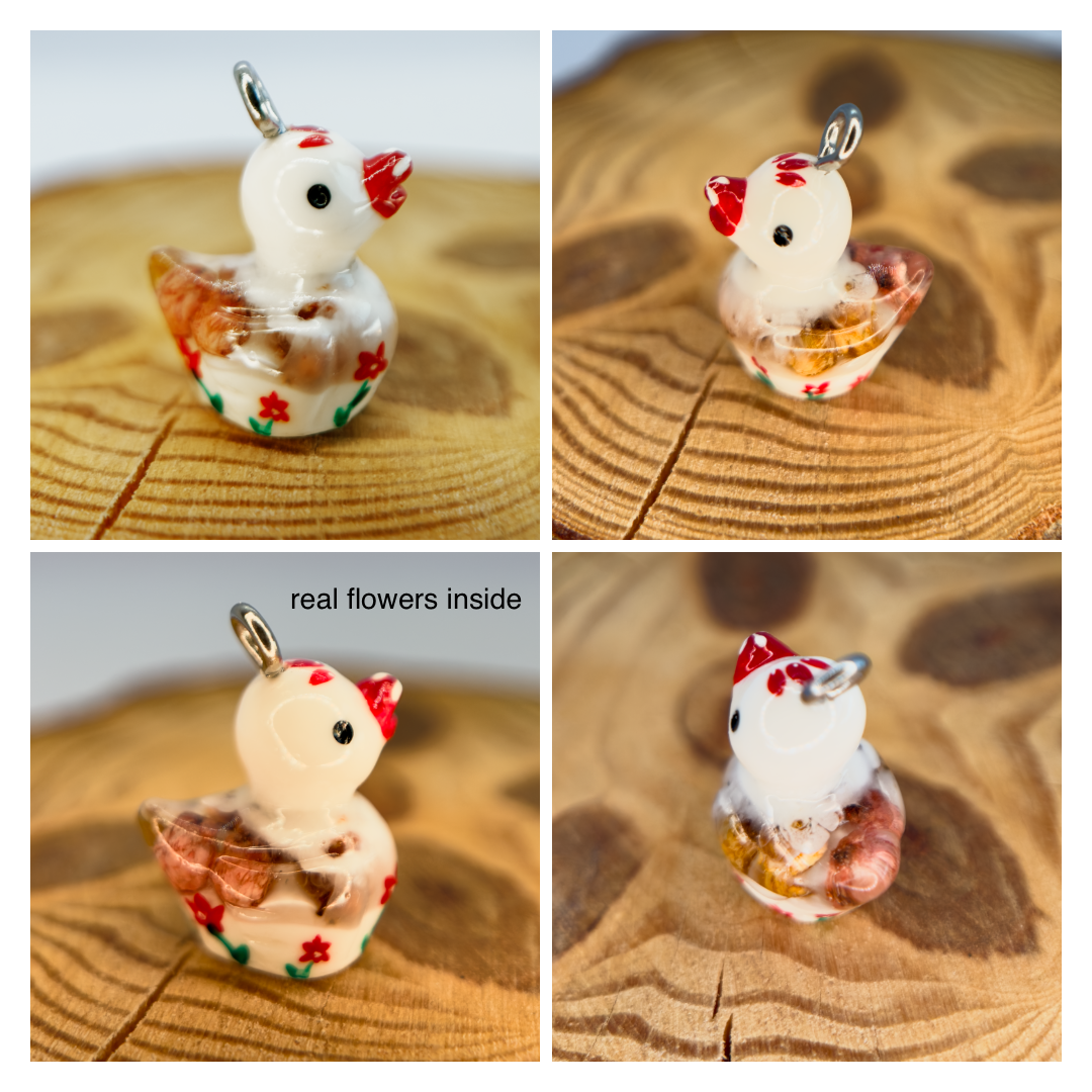 All pendants feature a miniature duck animal and hand-painted details.