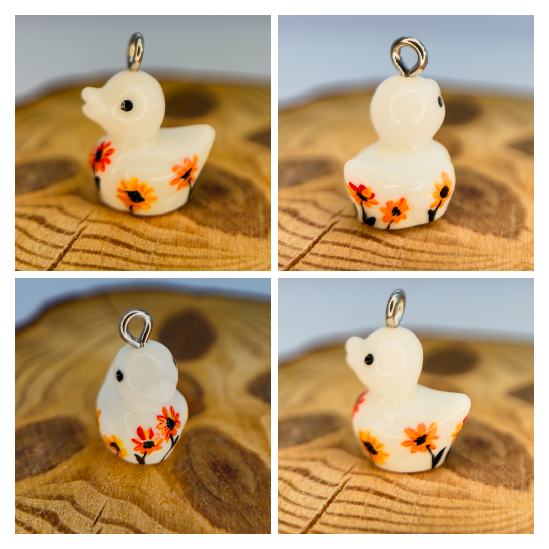 All pendants feature a miniature duck animal and hand-painted details.